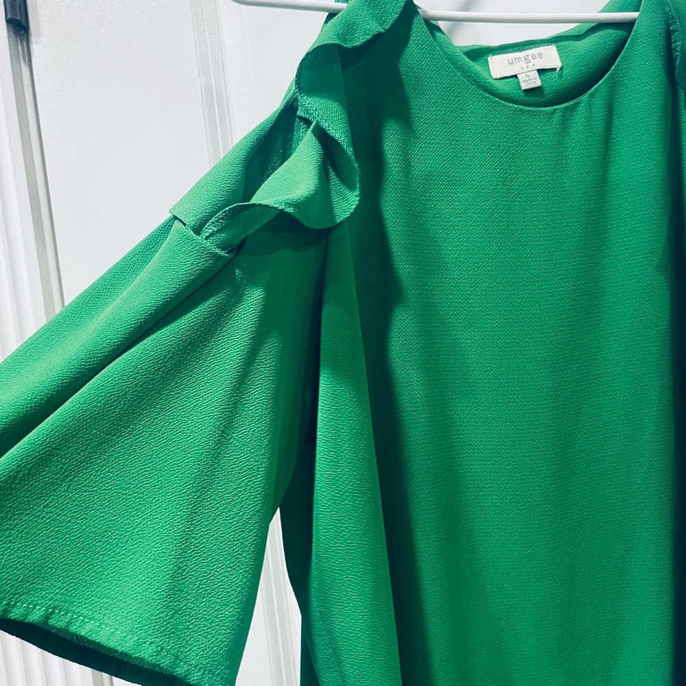Green blouse, with ruffles on sleeve, cut out at shoulder
